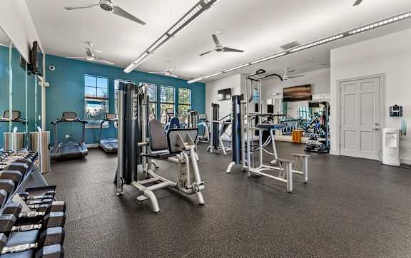 A large swimming pool surrounded by a grassy area and apartment buildings. at The Royce at 8100, Austin, TX, 78729