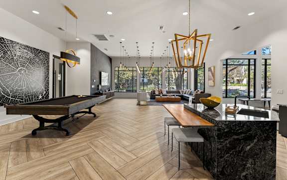 A large swimming pool surrounded by a grassy area and apartment buildings. at The Royce at 8100, Austin, TX, 78729
