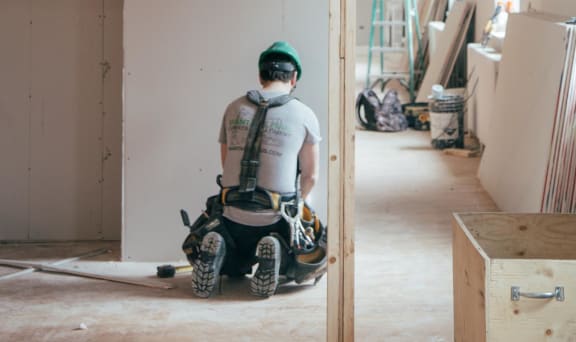 a man on a motorized scooter in a building under construction