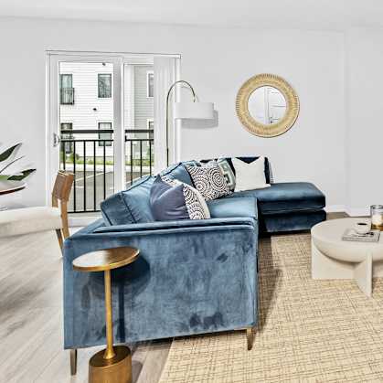 a living room with a blue couch and a tv