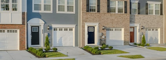 a row of townhomes with a blue sky in the background