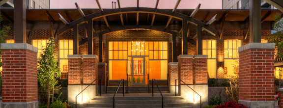 The entrance to the Liberty Gateway building is shown at dusk.