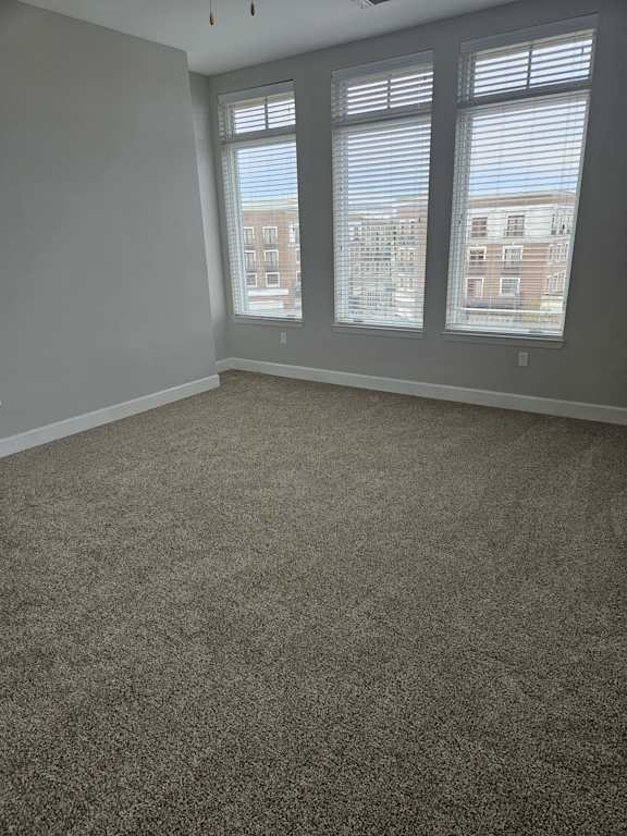 A room with a window overlooking a building.