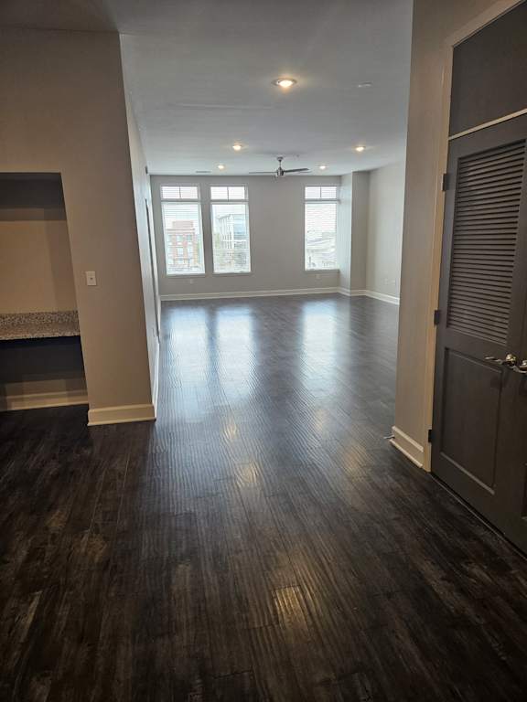 A room with a window and a wall with a wood grain pattern.