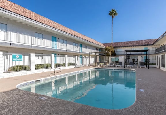A pool in a building with a sign that says