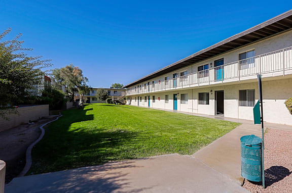 A sunny day at the apartment complex with a clear blue sky.