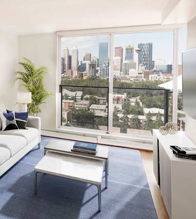 living toom with a couch, lamps, artwork, a TV and a balcony with a view