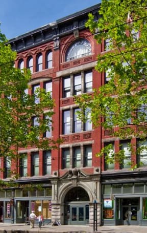 a large red building with a tree in front of it