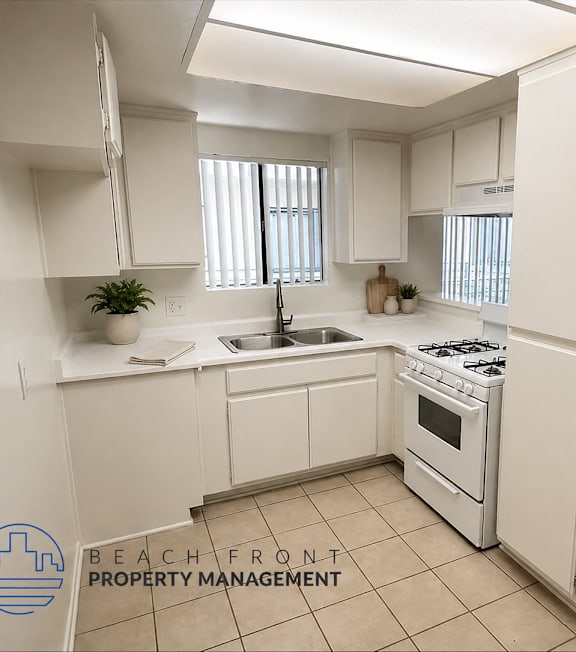 A well-lit, modern kitchen and living room with a dining area.