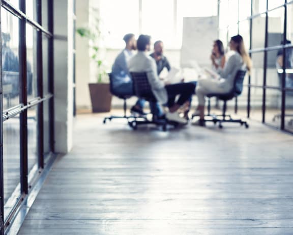 people sitting at a table in an office meeting