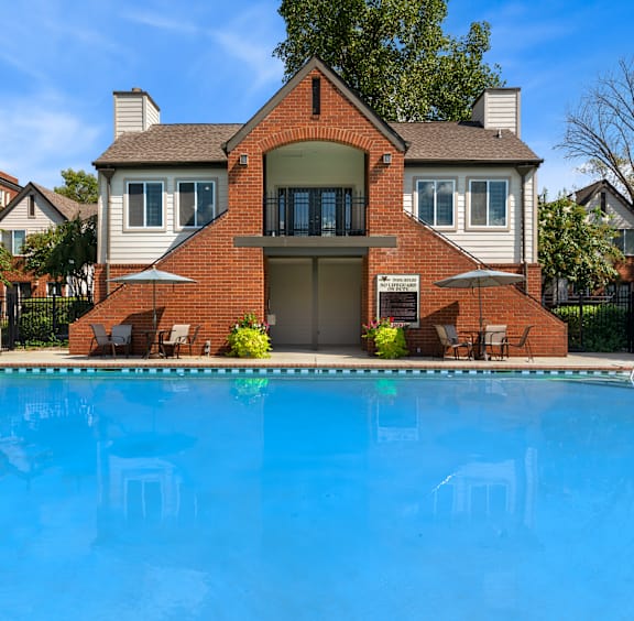 A house with a pool in front.
