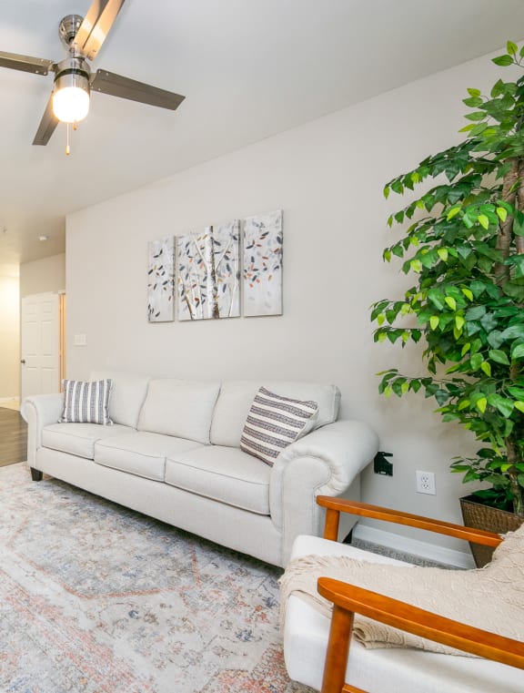 a living room with a white couch and a ceiling fan at Sunrise Canyon, Texas
