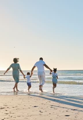 happy family walking on the beach