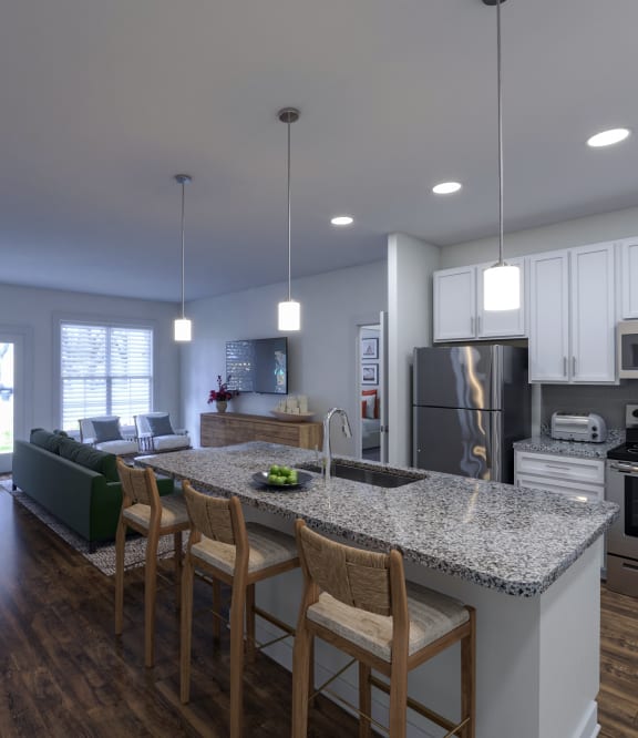 a kitchen and living room with white cabinets and a granite countertop at The Bella at Westchester, Virginia