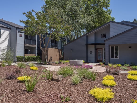 Pheasant Pointe apartments leasing office building exterior, fountain and landscaping 