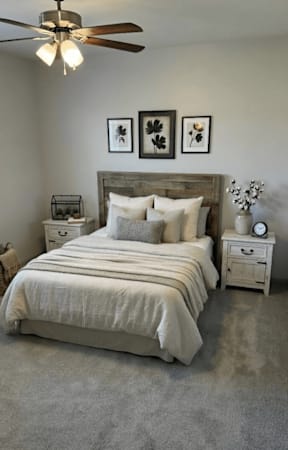 Bedroom with bed, nightstand, and ceiling fan in a furnished residential space.