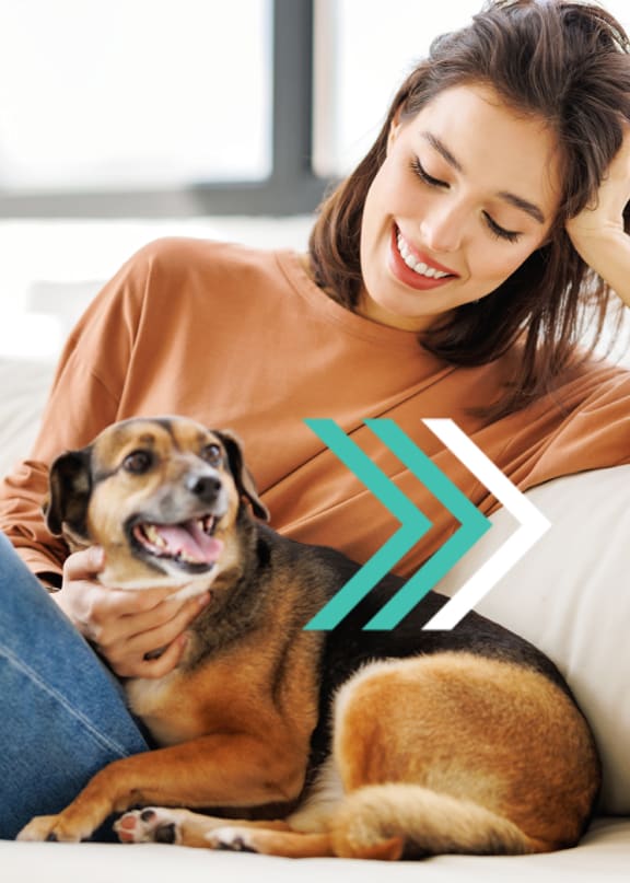 a woman sitting on a couch with her dog