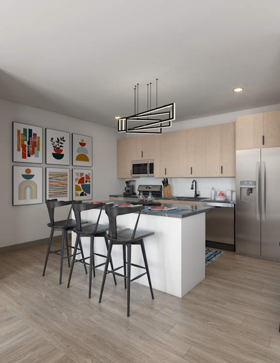 A modern kitchen with a large island and stainless steel appliances.