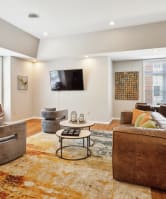 a sofa with white cushions in a living room