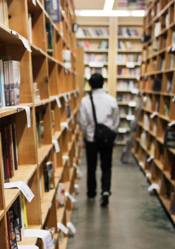 Man Walking in Book Store