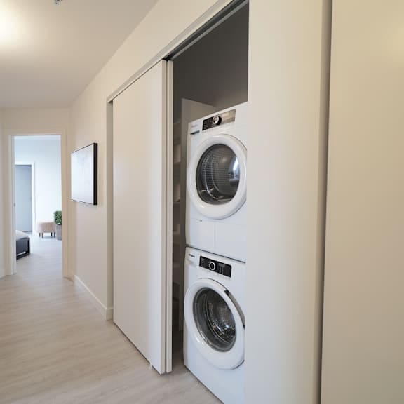A kitchen with wooden cabinets and a tiled floor.
