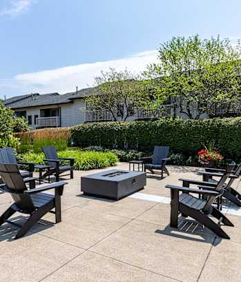 Patio with firepit and chairs at Woodland Meadows, Clinton Township, MI, 48035