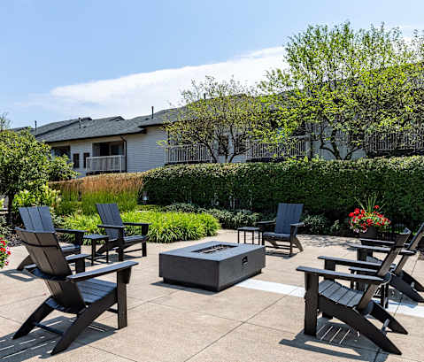 Patio with firepit and chairs at Woodland Meadows, Clinton Township, MI, 48035