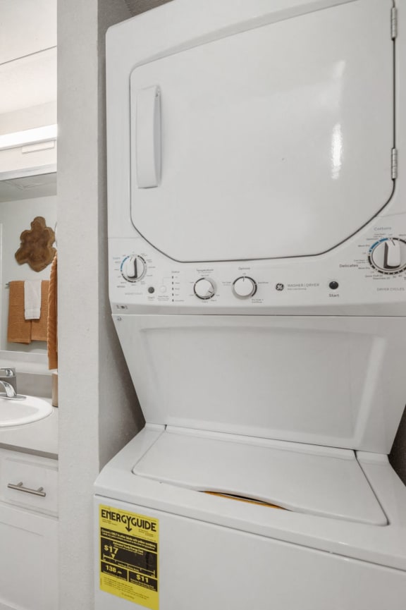 a kitchen with wooden cabinets and a black microwave