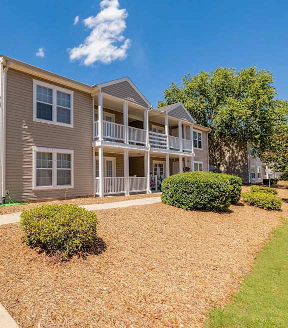 a swimming pool with lounge chairs and a building with a pool at Sanctuary Apartments & Townhomes, Augusta