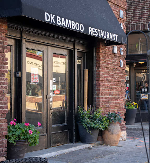 a restaurant with a sign that says mango thai cuisine