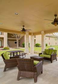 a backyard with a swimming pool and a barbecue grill