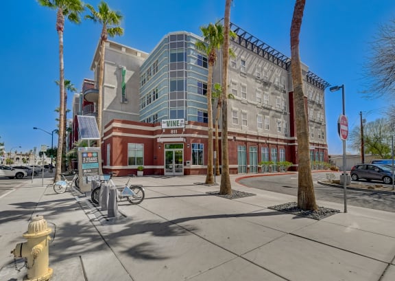 a building on a street corner with palm trees in front of it at The Vine on 8th, Las Vegas, Nevada