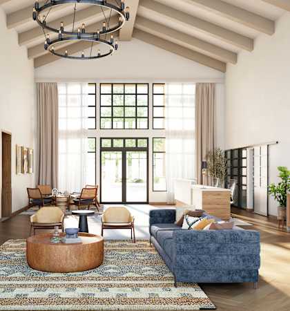 a living room with a fireplace and blue furniture and a large window