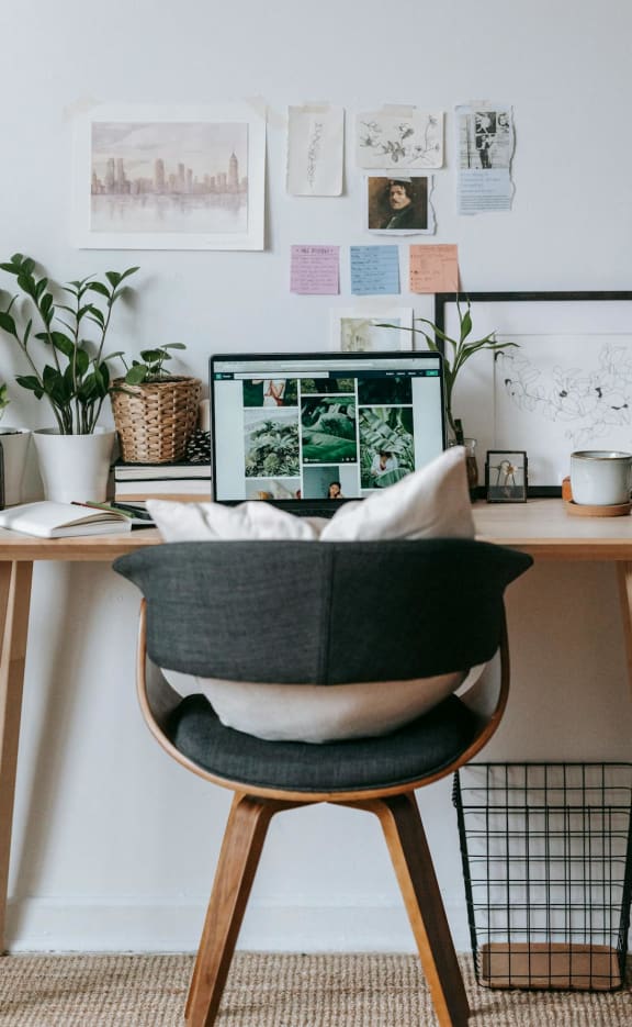 A home office with a desk, chair, and computer.