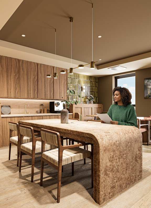 A modern office lobby with a reception desk and a green armchair.