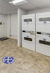 A laundry room with washers and dryers.