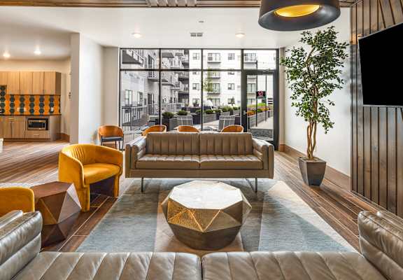 a lounge area with couches and chairs and a television at Northern Lights a Lifestyle-Driven Community, West Fargo, ND, 58078