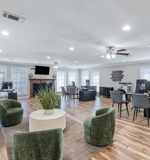 an open office space with green chairs and tables