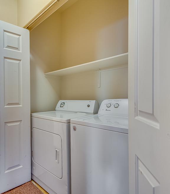 A small laundry room with a washer and dryer.
