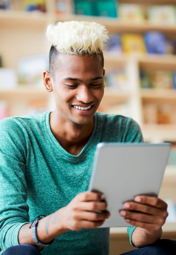 this is a photo of a young man browsing a tablet at the local bookstore.at Fairfield Pointe, Fairfield, OH