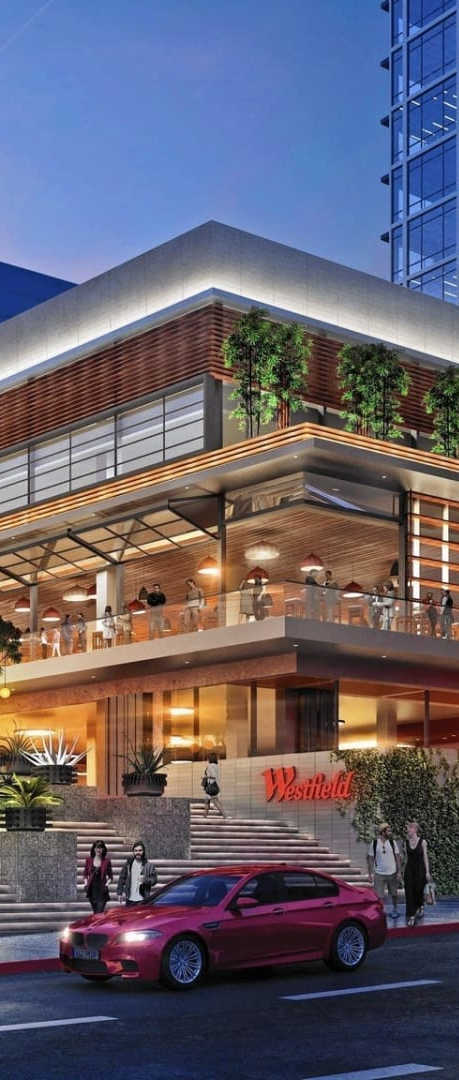 A modern building with a glass facade is the focal point of the image.