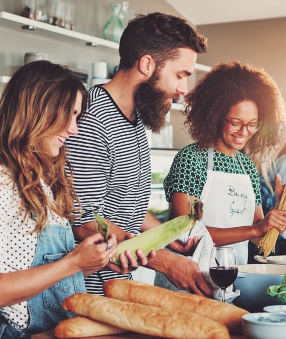 a group of people in a kitchen preparing food