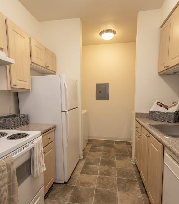 Stanford Heights model kitchen with wooden cabinets and white appliances