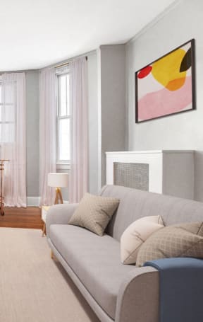 a living room with grey walls and a red brick fireplace