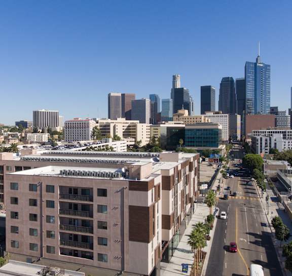 A cityscape with tall buildings and a clear blue sky at Wilshire Valencia Apartment, California