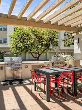 Outdoor patio with tables and two grills.