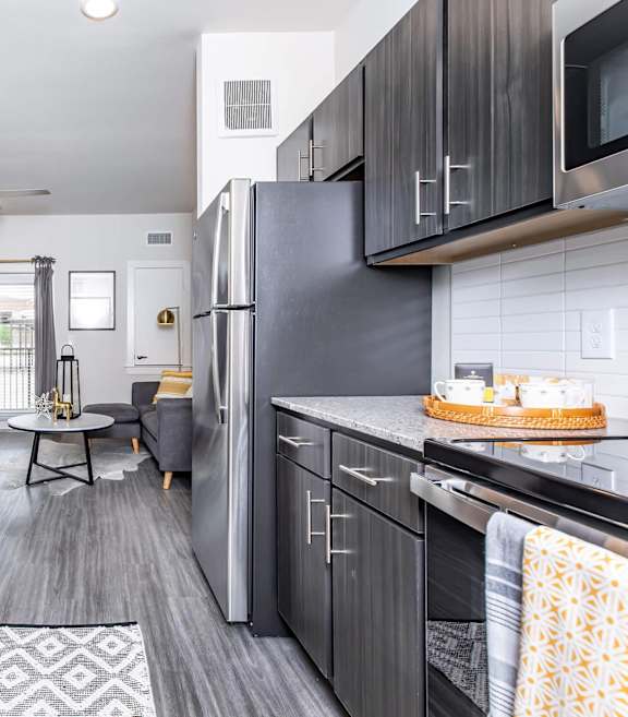 A modern kitchen with a large island and stainless steel appliances. at Sienna at Westover Hills Apartments, San Antonio, TX 78253