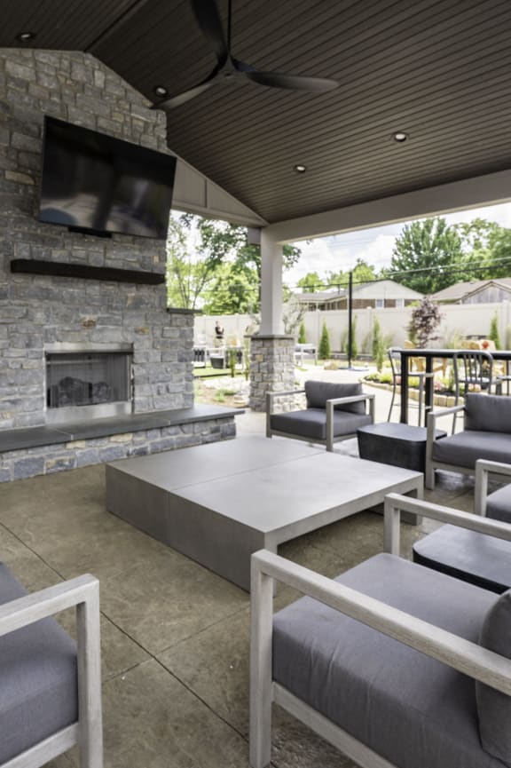 the outdoor patio has a fireplace and couches and tables at Olde Towne in Kenwood, Cincinnati, OH, 45243