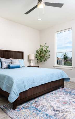 a bedroom with a bed and a ceiling fan at Mihir Taylor, Taylor, Texas