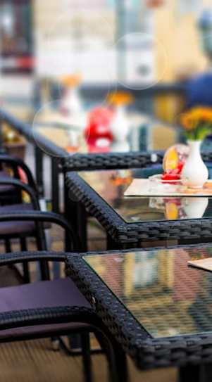 A woman is taking a selfie with a group of people at an outdoor dining area.